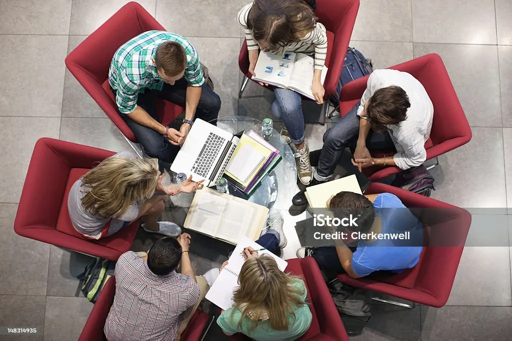 A group of people around a small table working.