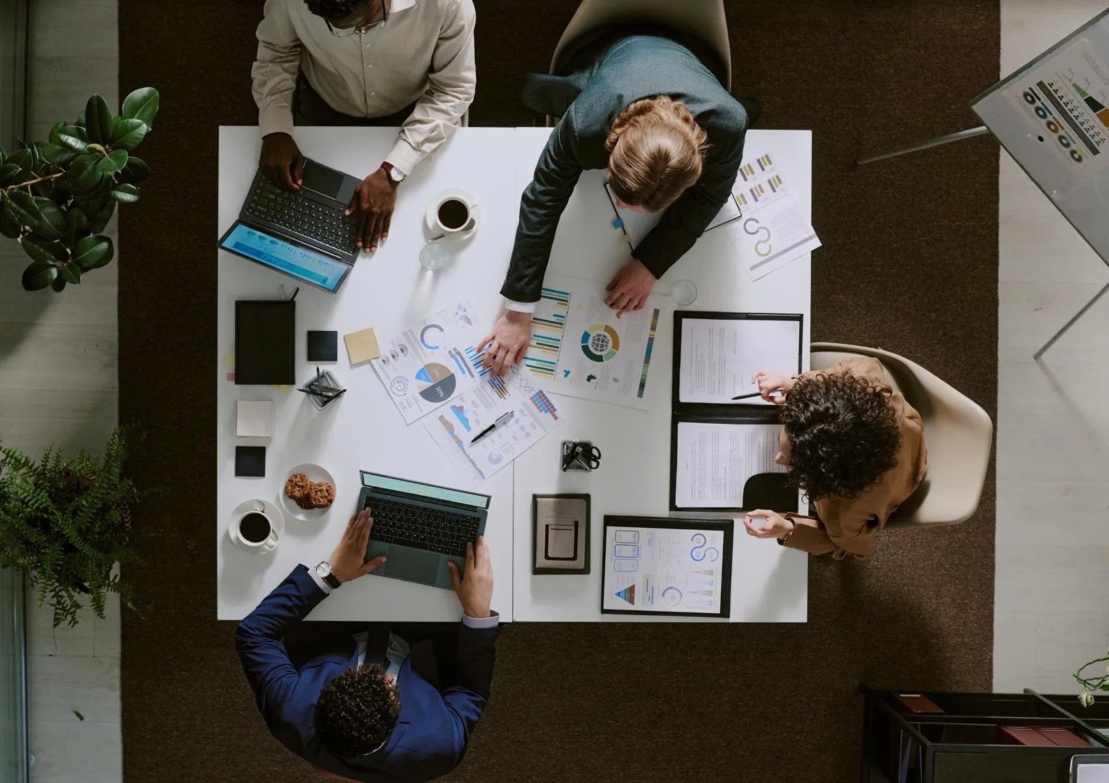 A group of people around a small table working.